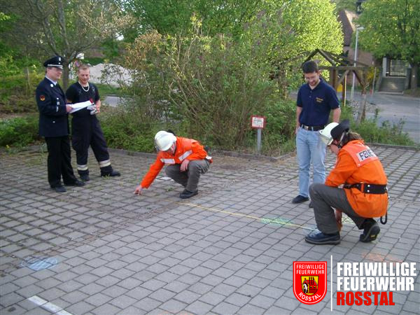 Bild 8 von 14 "Unterflurhydrantenfinden": Anhand von den Angaben auf einem Unterflurhydrantenschild, musste der richtige Hydrant durch Messen mit einem Meterband herausgefunden werden. Daf&uuml;r wurden zuvor meherer Hydranten mit Kreide auf den Hof gemalt.